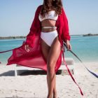 Woman in red dress standing on beach